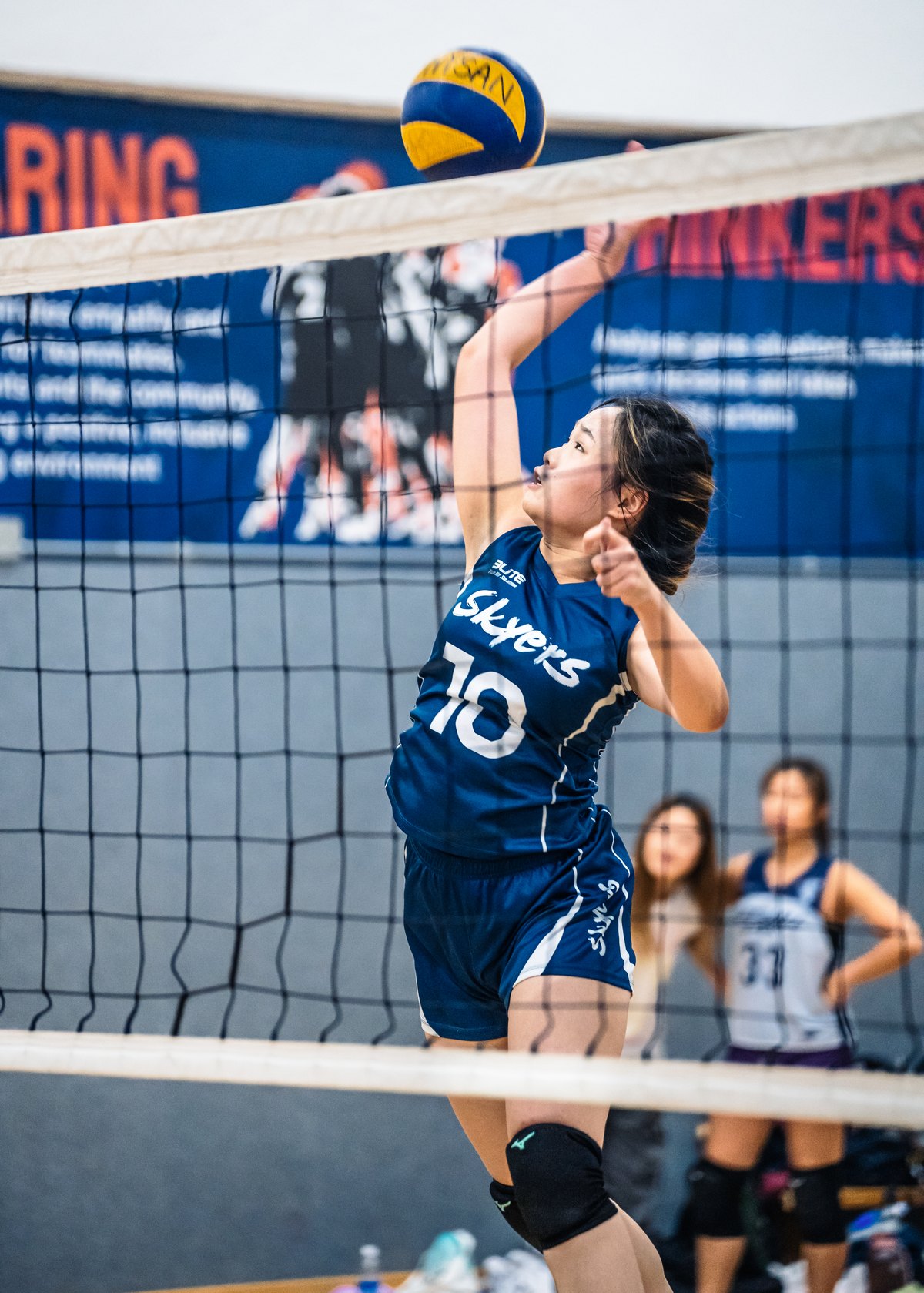 An HKU student spiking at an interhall volleyball match