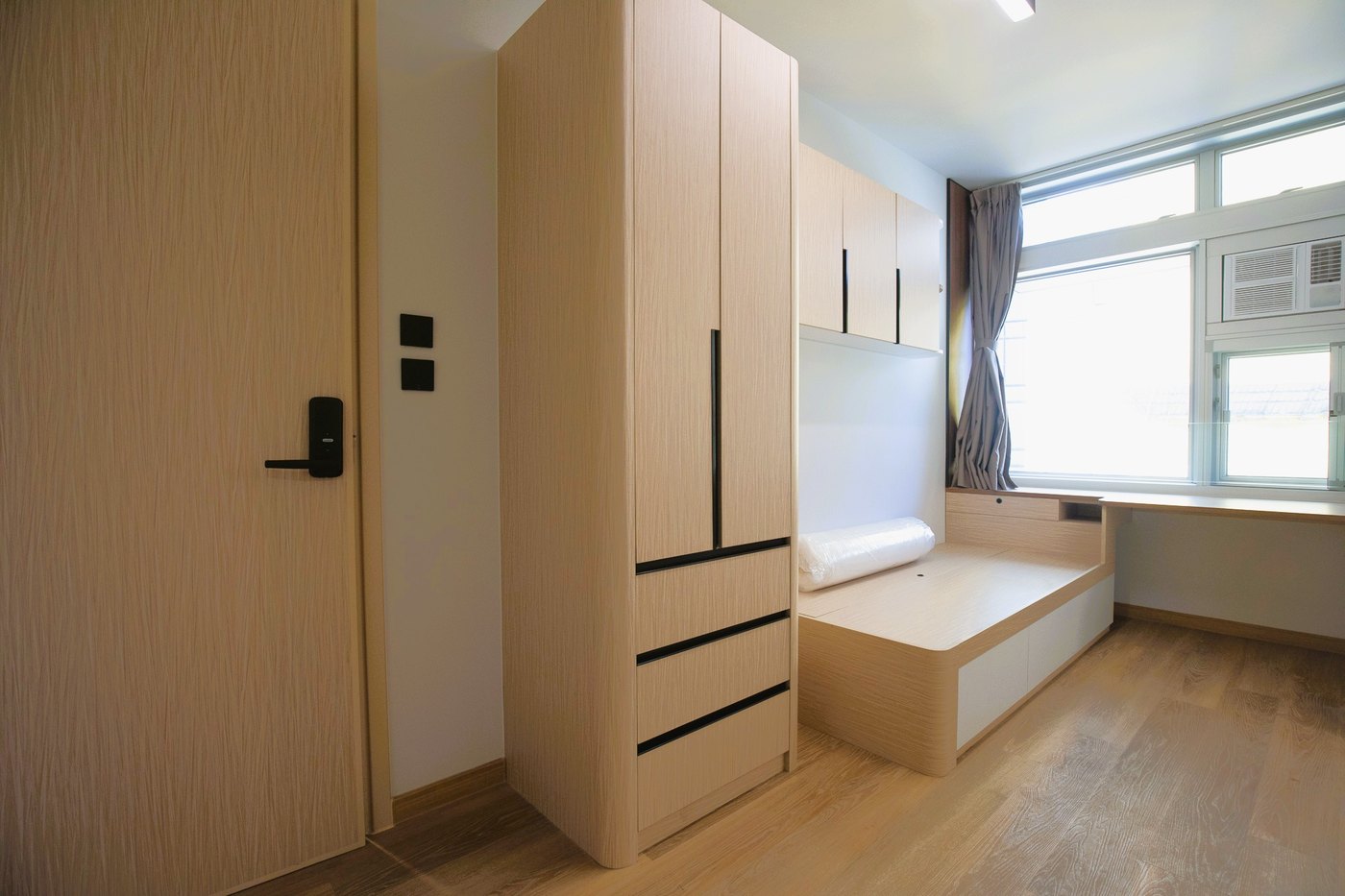 A single accessibility room with a wide doorway, wardrobe and platform bed